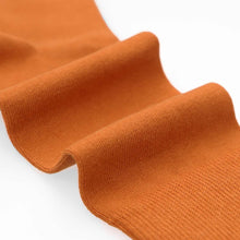 Load image into Gallery viewer, Close-up of burnt orange sock texture on a white background