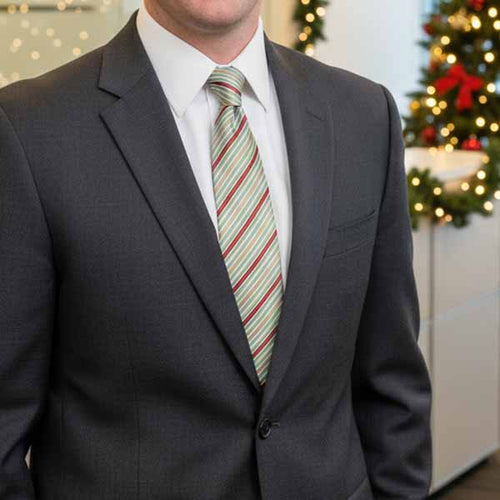 Businessman in office during holidays wearing a striped pattern tie with a charcoal suit