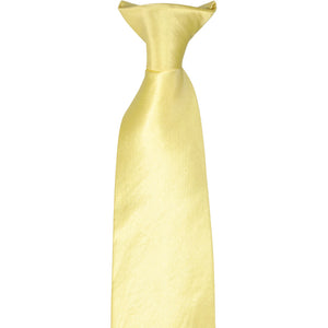 The knot on a butter yellow clip-on tie