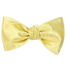 Load image into Gallery viewer, A solid color butter yellow self-tie bow tie, tied