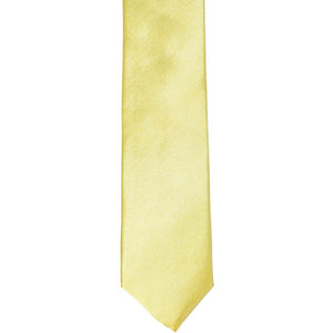 The front of a butter yellow skinny tie, laid flat