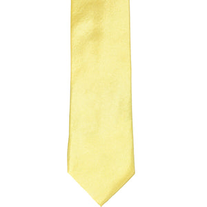 The front of a butter yellow slim tie, laid out flat