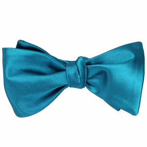 A solid self-tie bow tie, tied, in caribbean blue
