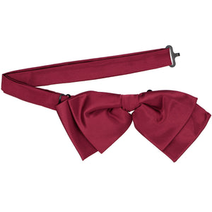 A claret red floppy bow tie with its pre-tied band collar