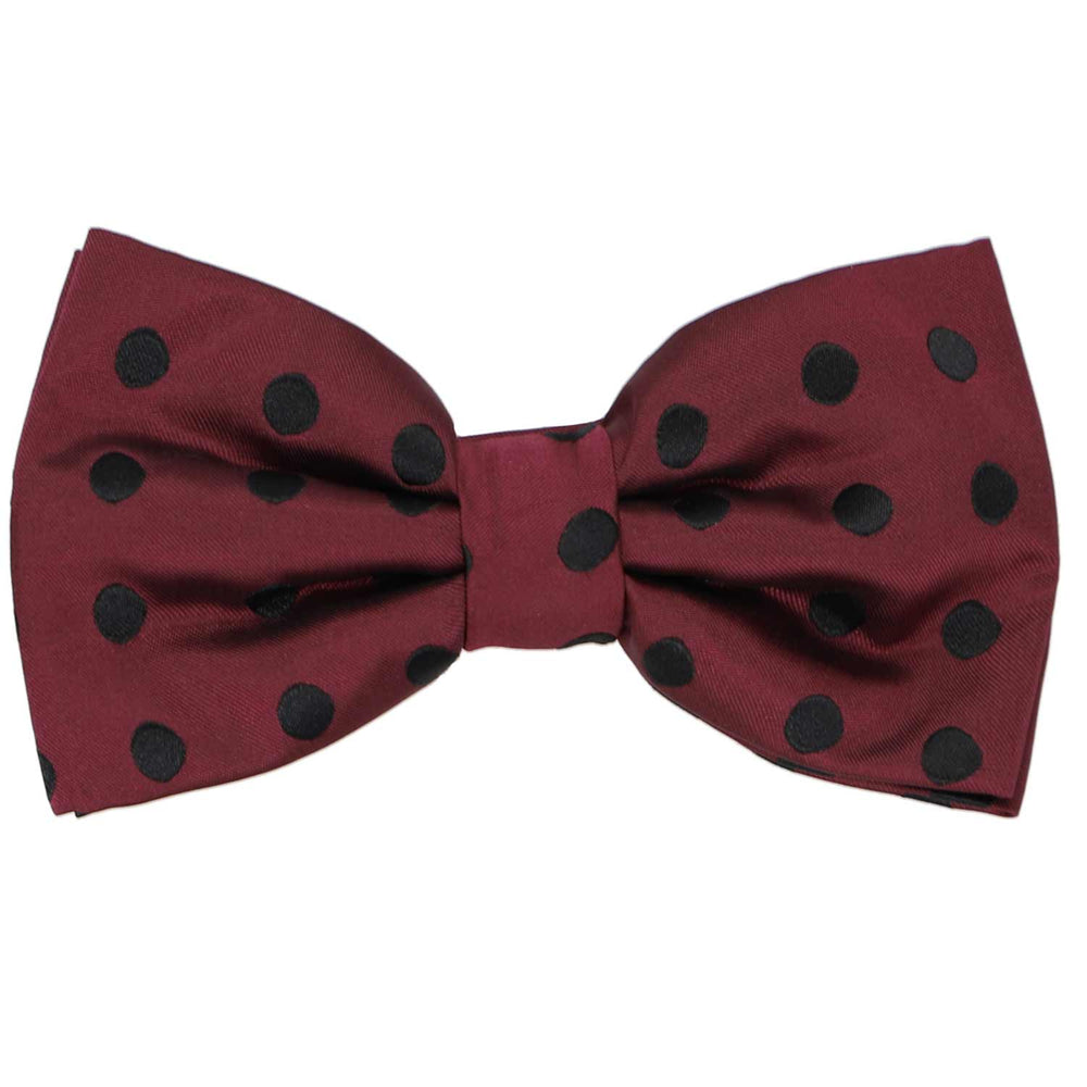 A pre-tied reddish brown bow tie with black medium-sized polka dots