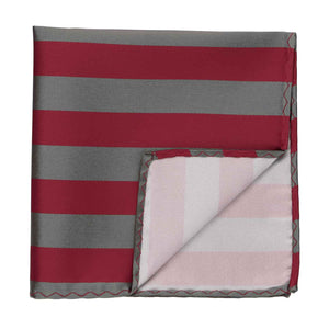 A crimson red and gray striped pocket square with the corner flipped up to show the back side