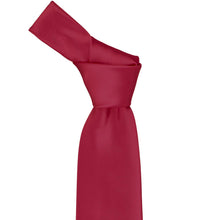 Load image into Gallery viewer, Close-up of a solid crimson red necktie knot, highlighting the deep red tone and subtle ribbed texture of the fabric