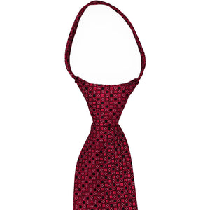 The knot and collar on a crimson red square pattern zipper tie