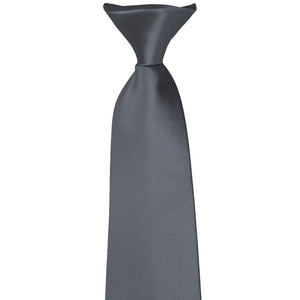 The knot on a dark gray clip-on tie
