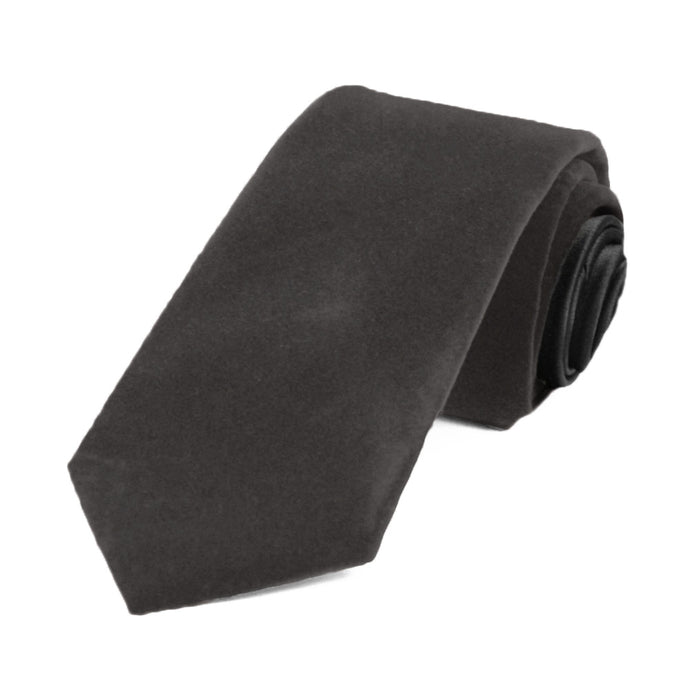 A dark gray velvet tie, rolled to show off the front