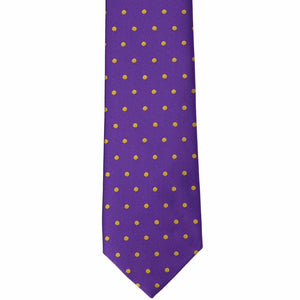 The front of a dark purple and gold polka dot necktie