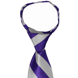 The pre-tied knot on and dark purple and silver striped zipper tie