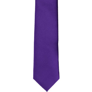 The front of a dark purple skinny tie, laid flat