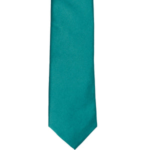 The front of a deep aqua slim tie, laid out flat