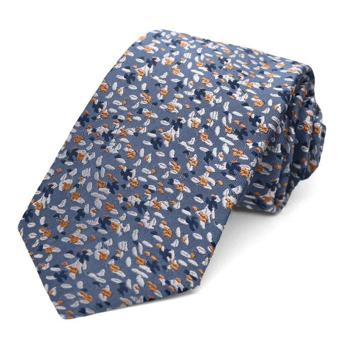 A dusty blue and antique gold grain pattern tie, rolled