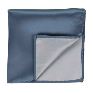 A dusty blue pocket square with the corner flipped up to show the inside