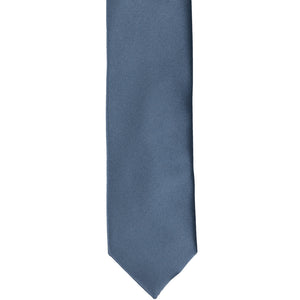 The front of a dusty blue skinny tie, flat