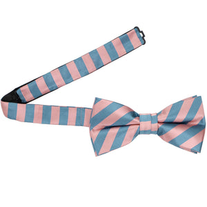 A dusty pink and blue striped bow tie with the band collar open