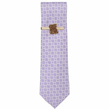 Load image into Gallery viewer, A chocolate Easter bunny tie bar in brown and gold on a purple patterned necktie