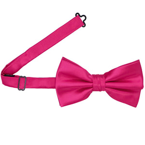 A fuchsia pre-tied bow tie with the band open