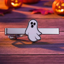 Load image into Gallery viewer, Ghost-shaped tie clip on a wooden surface with Halloween pumpkins in the background