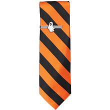 Load image into Gallery viewer, Novelty silver tie bar with a black and white ghost emblem on a black and orange striped tie.