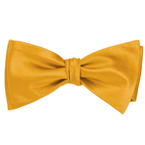 A gold bar self-tie bow tie, tied
