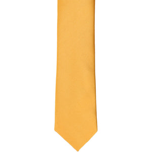 The front of a gold bar skinny tie, laid flat