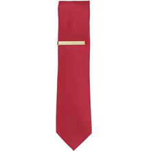 Load image into Gallery viewer, A solid gold tie bar on a red slim tie