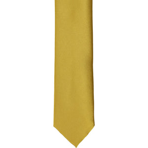 The front of a gold skinny tie, laid flat
