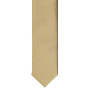 The front of a golden champagne skinny tie, flat