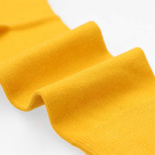 Load image into Gallery viewer, Close up of the fabric on a men's golden yellow sock