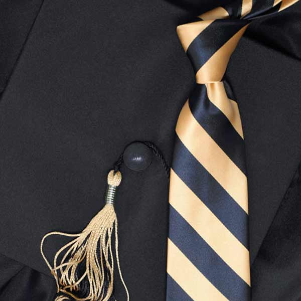 A black and gold striped tie on top of a graduation cap
