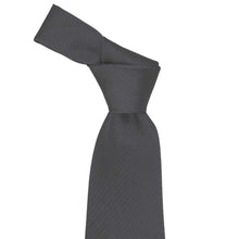 Load image into Gallery viewer, Knot on a graphite gray herringbone necktie on a white background