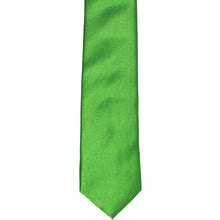 Load image into Gallery viewer, The front of a grass green skinny tie, laid flat