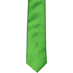 The front of a grass green skinny tie, laid flat