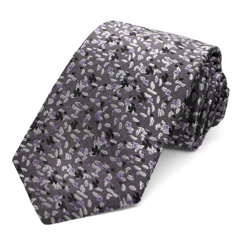 A dark purple and gray grain pattern tie, rolled
