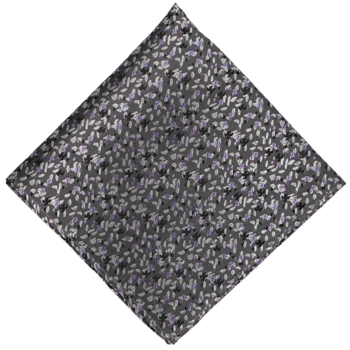 A dark gray pocket square with a lavender scattered grain pattern