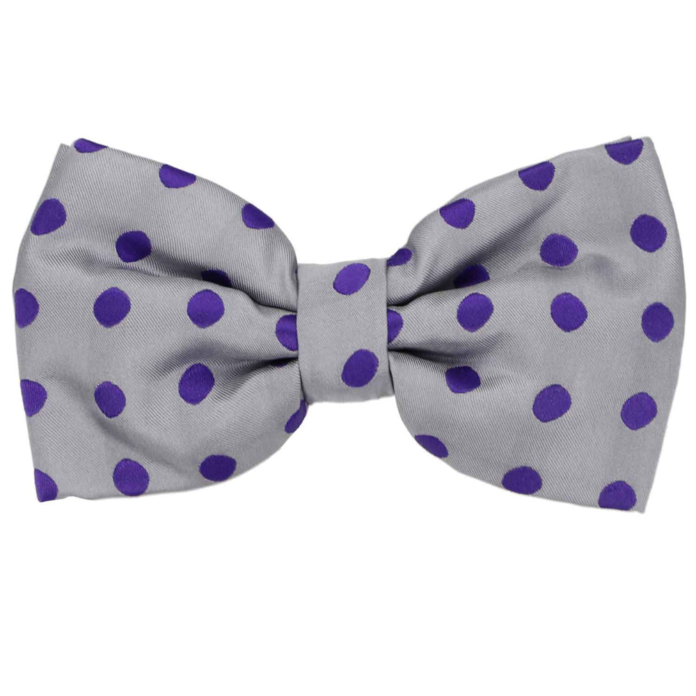 A playful gray bow tie with purple polka dots all over