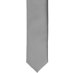 The front of a gray skinny tie, laid flat