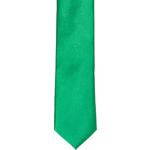The front of a green skinny tie, laid flat