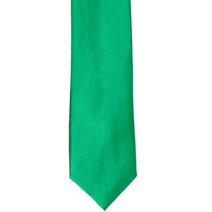 The front of a green slim tie, laid out flat