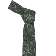 Load image into Gallery viewer, A dark green narrow necktie with a light sage green paisley pattern, tied in a knot and displayed against a solid white background.