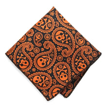 Load image into Gallery viewer, An orange and black skull and crossbones pattern halloween pocket square, folded into a diamond shape