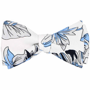 A blue, gray and white Hawaiian floral self-tie bow tie, tied