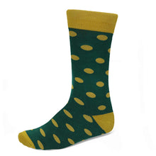 Load image into Gallery viewer, A single crew sock with a dark green base, gold polka dots and gold trim on the cuff, heel, and toe, shown against a plain white background.