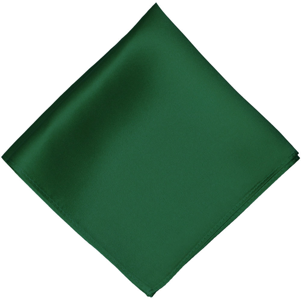 A hunter green silk pocket square, folded into a diamond