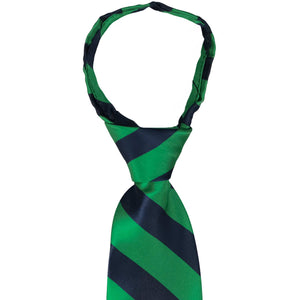 A closeup of the knot on a kelly green and navy blue striped zipper tie