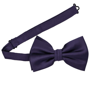 A pre-tied large lapis bow tie with the band collar open