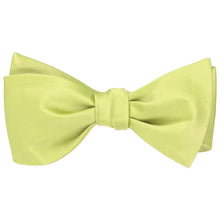 Load image into Gallery viewer, A solid lemon lime self-tie bow tied, tied